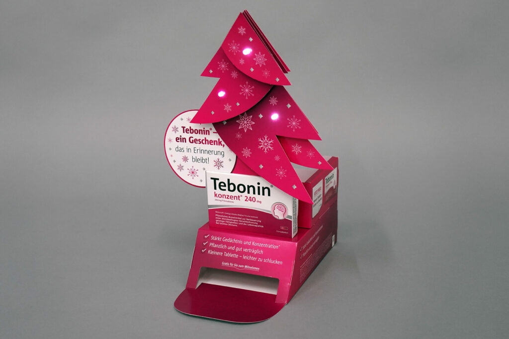 HV-Aufsteller für das Medikament Tebonin mit einem pinken Tannebaum und der Produktverpackung darunter, produziert von pod GmbH