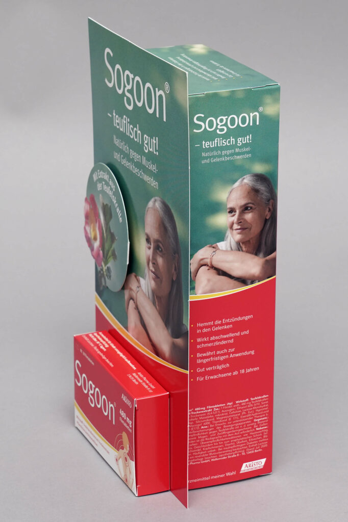 HV- Aufsteller für das Medikament Sogon, berduckt mit einer lächelnden Frau an der Rückseite und einer Nachbildung der Produktverpackung an der Vorderseite, produziert von pod GmbH