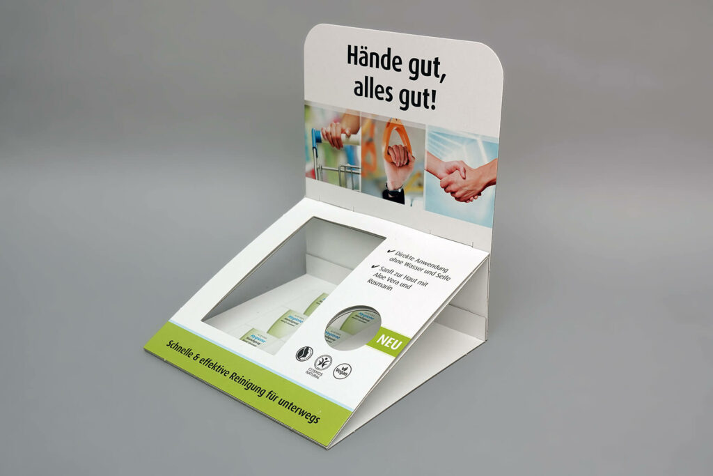 Klappdisplay für ein Handreinigungs-Spray mit der Aufschrift "Hände gut, alles gut!" von pod GmbH