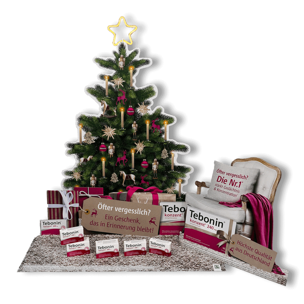 Schaufensterdekoration von pod GmbH für das Medikament Tebonin - bestehend aus einem geschmückten Weihnachtsbaum im Hintergrund, einem Chesterfield-Sessel rechts daneben und mehreren Geschenken und Medikamenten-Packungen im Vordergrund